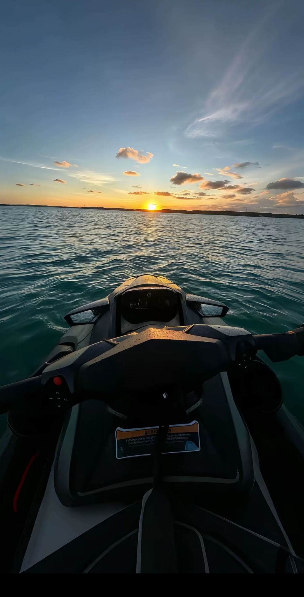 Jetski at sunset on calm sea