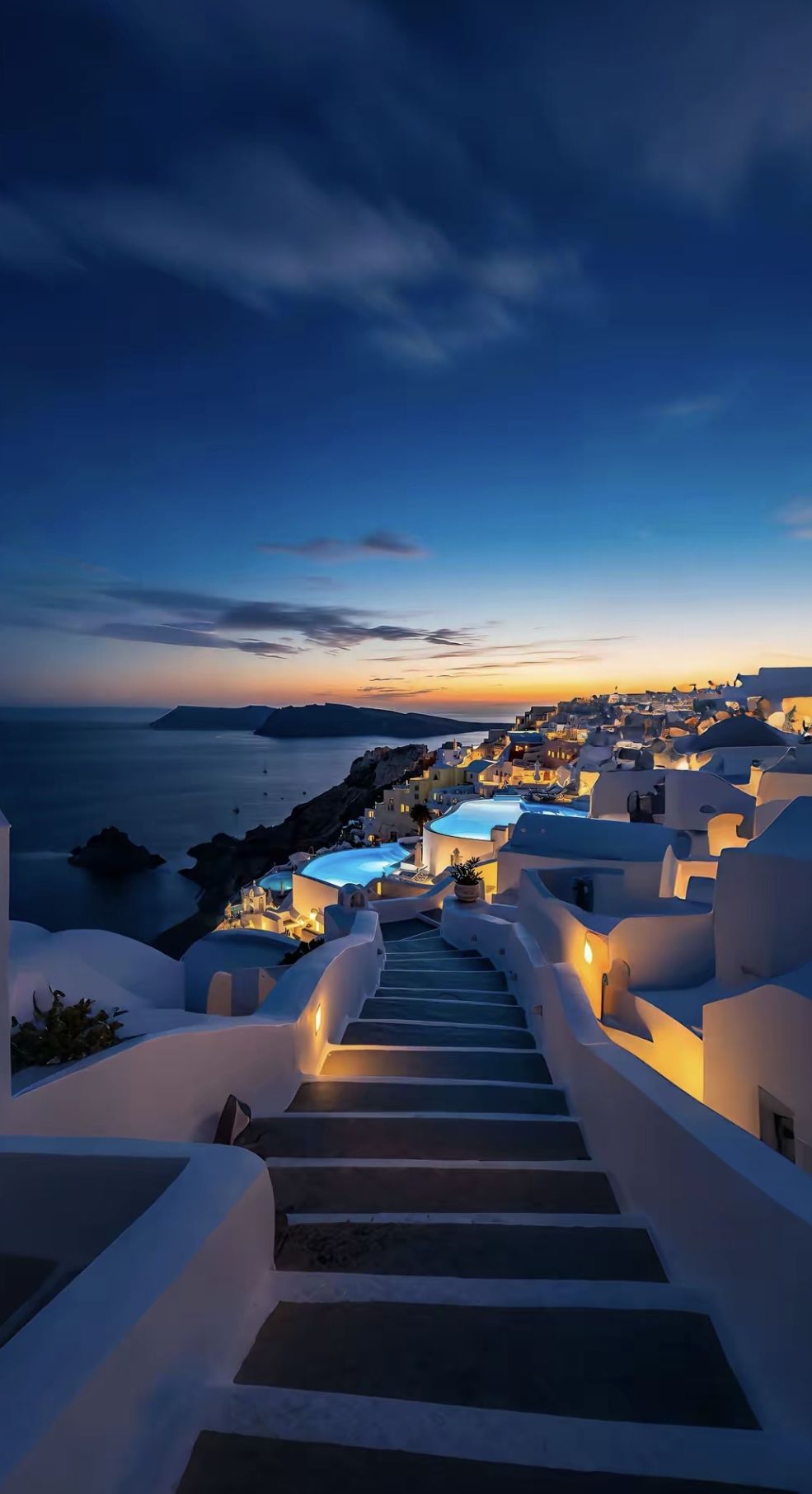 Santorini caldera at dusk with blue-domed rooftops and sea view